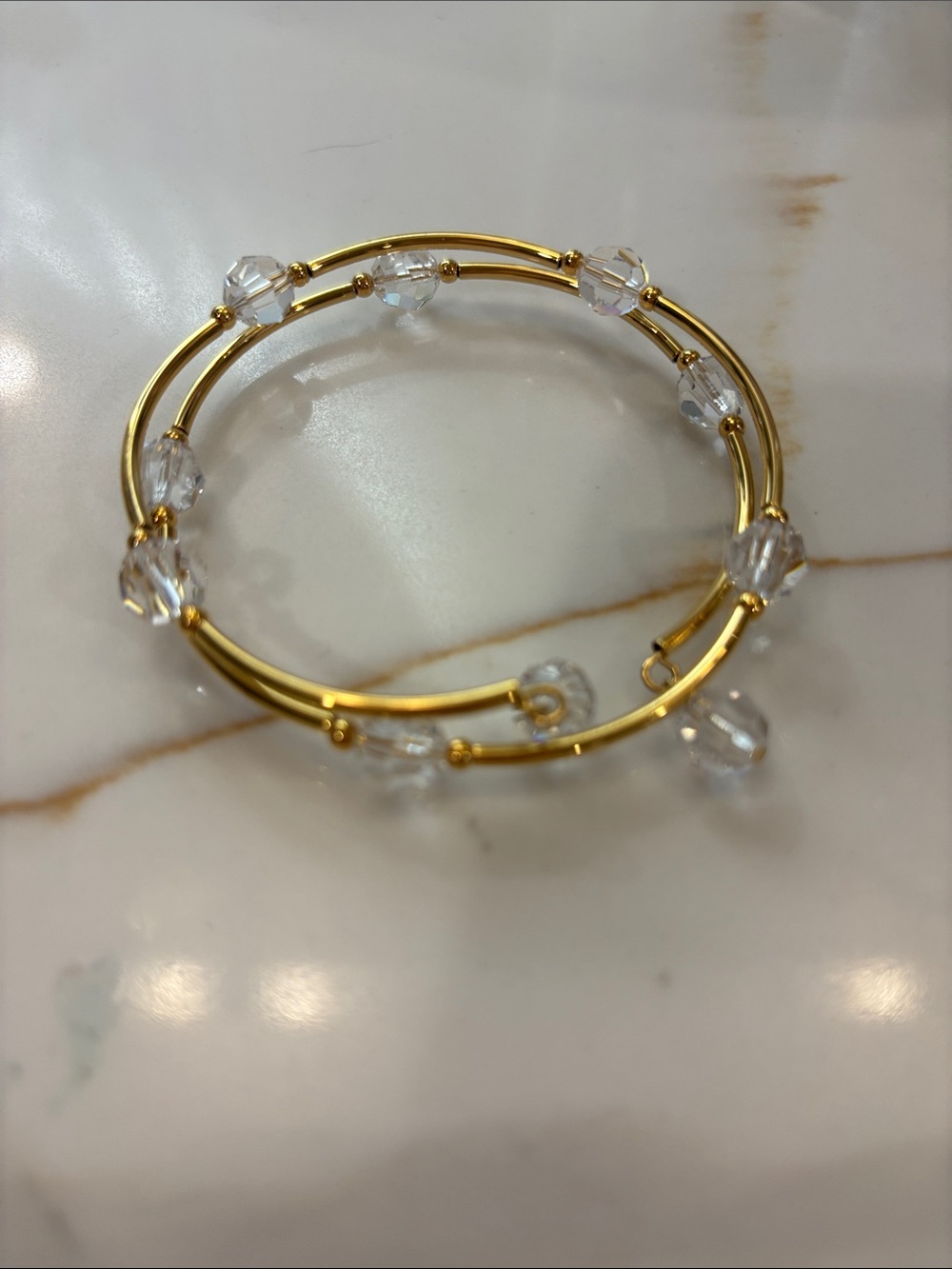 Touchstone Crystal Gold Tone Bangle Bracelet with Clear Crystal Beads